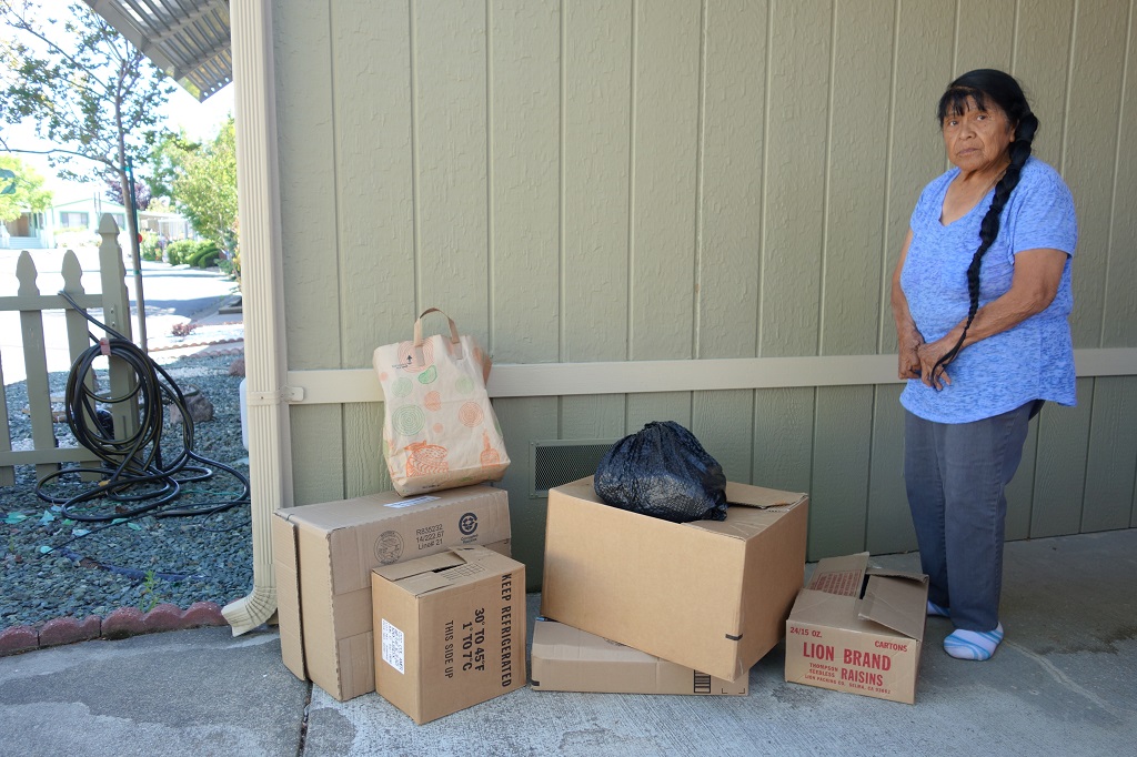 Tribal elder and ( FFTF ) Director Mildred Burley stands with some of this months donations received from concerned local residents in response to the government's lack of fulfilling trust responsibilities