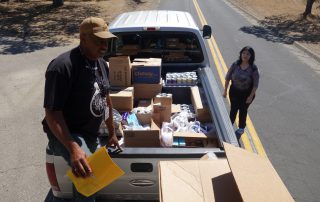 California Valley Miwok Tribal staff helps unloading good supplies.