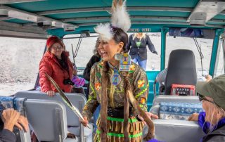 Alaskan Native American woman wearing traditional clothes in a bus during an Indian tour.