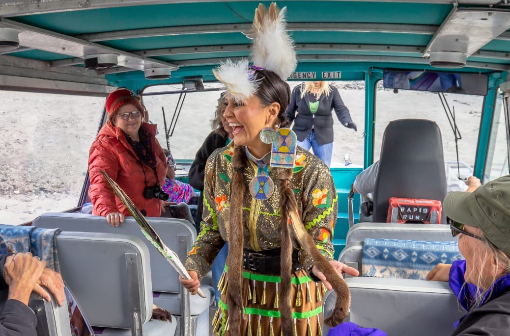 Alaskan Native American woman wearing traditional clothes in a bus during an Indian tour.