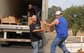 California Valley Miwok Tribal staff unloads boxes during a food distribution.