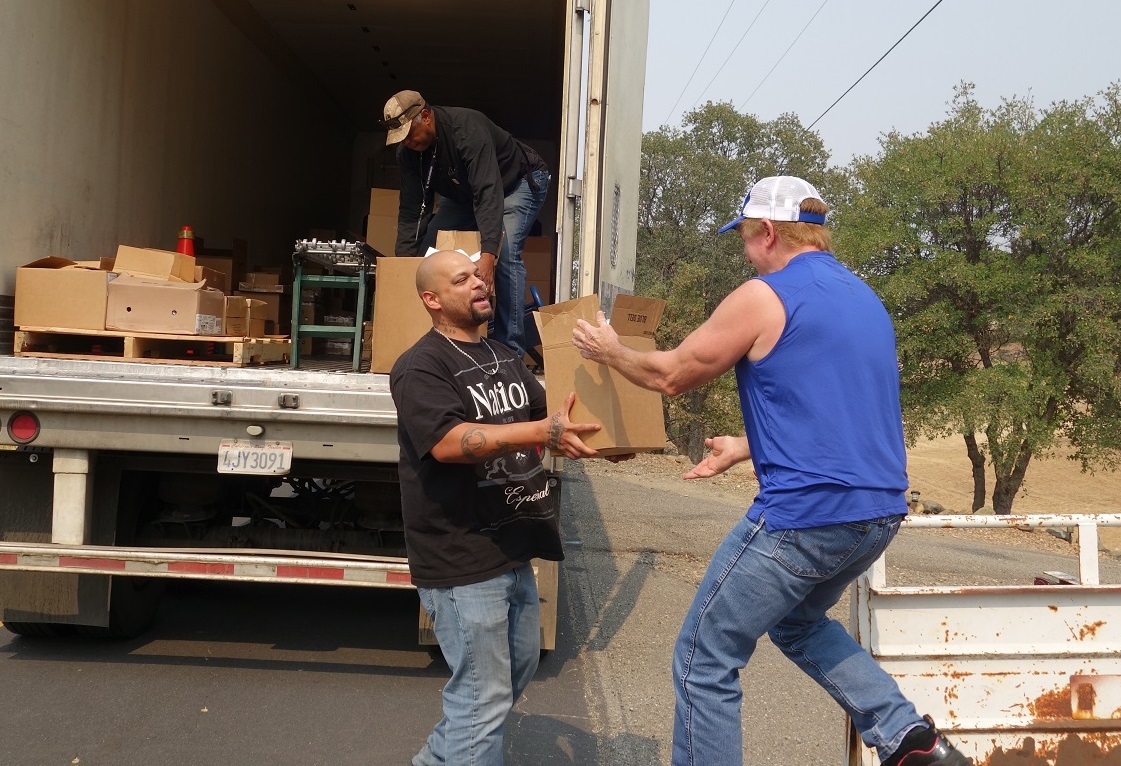 California Valley Miwok Tribal staff unloads boxes during a food distribution.