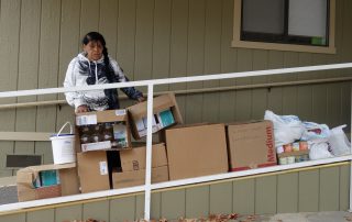 California Valley Miwok Tribal elder Mildred Burley with good supplies from the Food For Tribal Families program.
