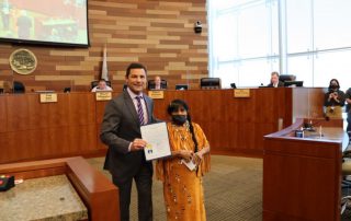 California Valley Miwok Tribal elder Mildred Burley with Tom Patti, holding the Indigenous Peoples’ Day proclamation.