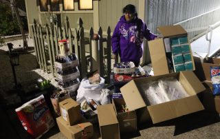 California Valley Miwok Tribe's elder Mildred Burley standing with supplies from Food for Tribal Families Program.