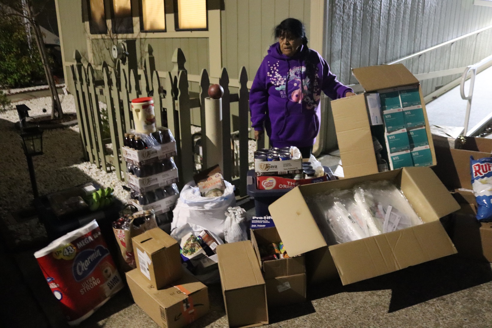 California Valley Miwok Tribe's elder Mildred Burley standing with supplies from Food for Tribal Families Program.