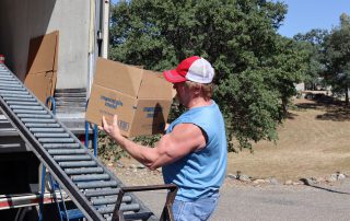 California Valley Miwok Tribe's staff Tiger Paulk carrying goods boxes during a distribution.