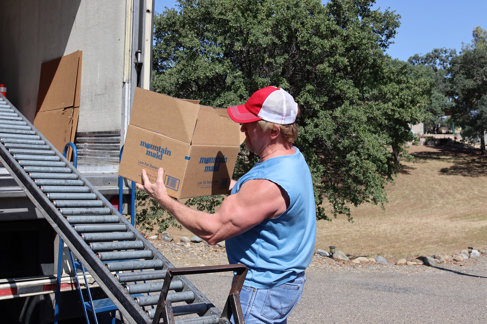 California Valley Miwok Tribe's staff Tiger Paulk carrying goods boxes during a distribution.