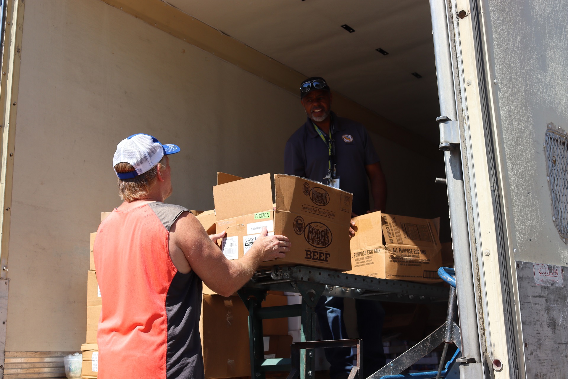 California Valley Miwok Tribe staff member Tiger Paulk is helping Ronald Buckman to unload good supplies.