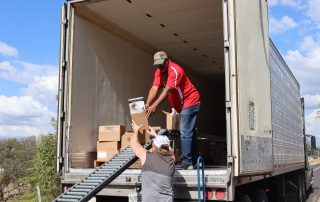Ronald Buckman and Tiger Paulk are unloading goods for the California Valley Miwok Tribe.