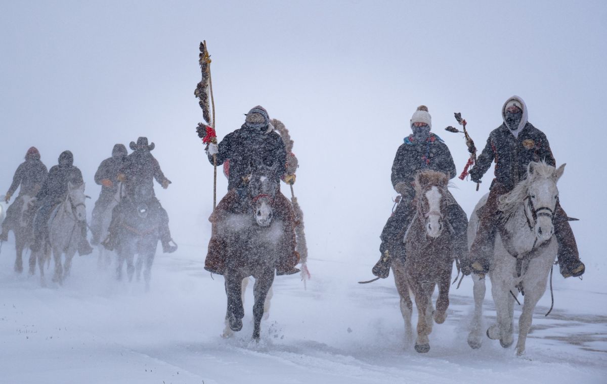 Dakota Horseback riders in the snow.