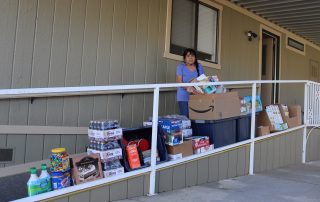 Mildred Burley standing in front of goods being delivered on April 16th, 2023.