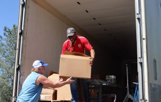 Ronald Buckman helping California Valley Miwok tribal staff Tiger Paulk to deliver goods for the tribe.