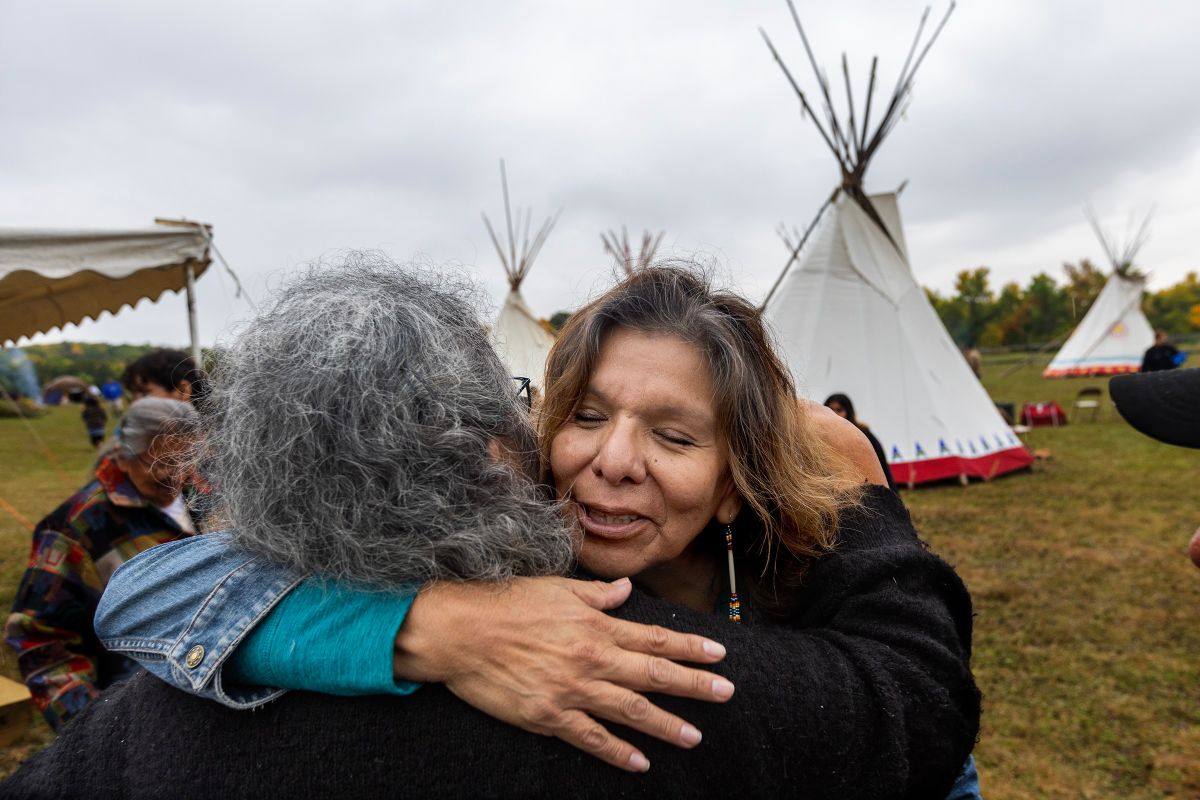 Kelley Bova, right, receives a hug after speaking to a group of elders at the Lake Traverse Reservation in South Dakota on Sept. 23, 2023.