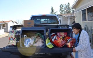 Miwok tribal elder Mildred Burley loading goods onto truck during the February 2024 Food For Tribal Families Program.