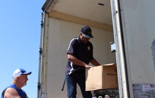 Ronald Buckman helping CVMT staff to unload some goods during the July 2024 USDA food distribution.