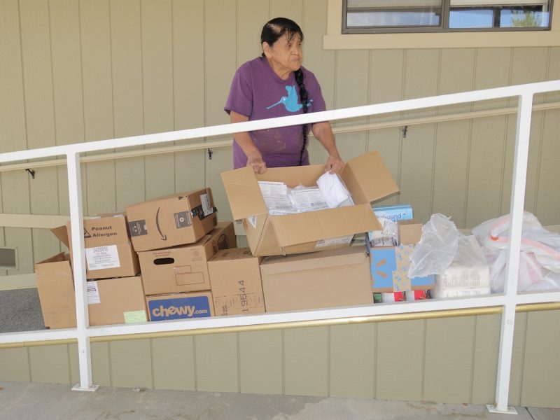 Program Director Mildred Burley holds open box of FEMA supplied face masks many of which were already distributed. Note the abundance of this month's delivery. July 2020 Food For Tribal Families Distribution
