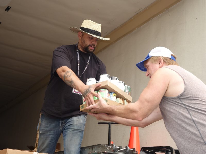 Tule River Specialist " Naz " handing product to CVMT tribal staff while keeping social distancing.