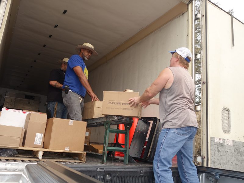 Specialist's Ronald Buckman and Naz discussing with tribal staff during distribution the current plight of various tribes and of the fire danger threatening their home lands.