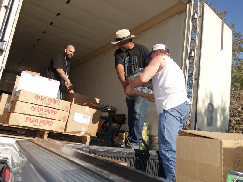 Specialist Ronald Buckman extends his arms to keep as much distancing as possible in the exchange of delivery.