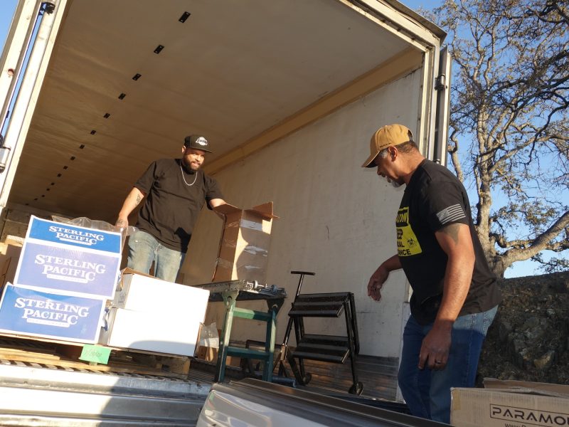 USDA Tule River Food Distribution Specialist Naz bringing Ronald Buckman one last box to finish off a distribution.