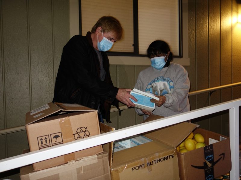 CVMT Tribal Staffer showing Program Director, Mildred Burley, the newer supplies acquired through a program with the California Office of Emergency Services and its representatives Daniel and Mark.