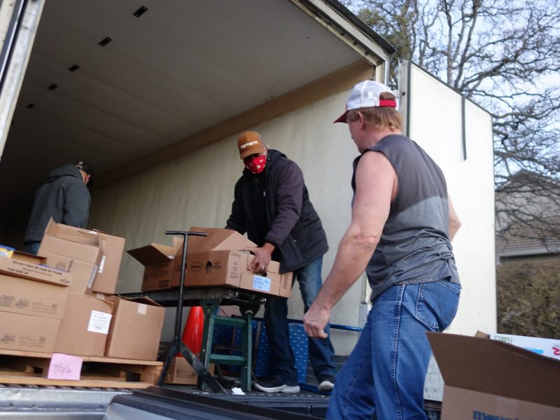 As Tule River Specialist Naz loads distribution, Specialist Ronald Buckman prepares to transfer to tribal staff.