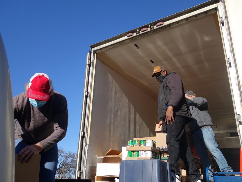 As Naz has conveyor full, Ronald Buckman waits for tribal staff to finish stacking previous boxes.