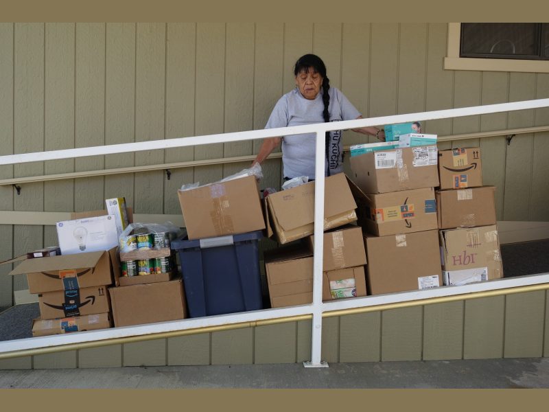 Food For Tribal Families, Program Director, Mildred Burley Stand's with this month's delivery.