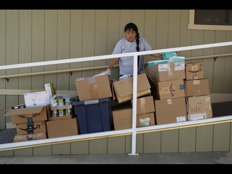 Food For Tribal Families, Program Director, Mildred Burley Stand's with this month's delivery.