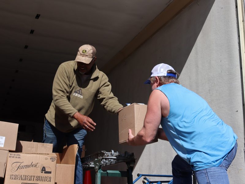 Specialist Ronald Buckman handing last of distribution to tribal staff to load for a family not in attendance.
