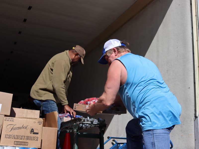 As tribal staffer receives frozen items topped with bags of strawberries, specialist Ronald Buckman pulls distribution forward that includes frozen Salmon.