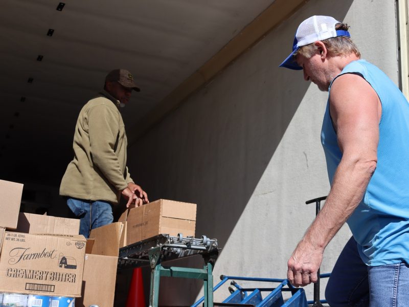 Last distribution of the day With Ronald Buckman and tribal staff pictured additional staff photographing and Specialist Naz far to back of delivery truck loading conveyor not pictured.