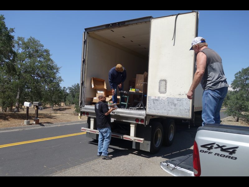 In one of the distributions tribal staff waits for Specialist ( Naz ) while specialist Ronald Buckman checks conveyor on one family's distribution. California Valley Miwok Tribe staff member Tiger Paulk waiting for Naz to bring good supplies