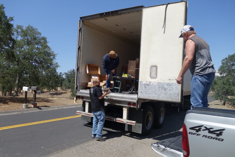 In one of the distributions tribal staff waits for Specialist ( Naz ) while specialist Ronald Buckman checks conveyor on one family's distribution. California Valley Miwok Tribe staff member Tiger Paulk waiting for Naz to bring good supplies