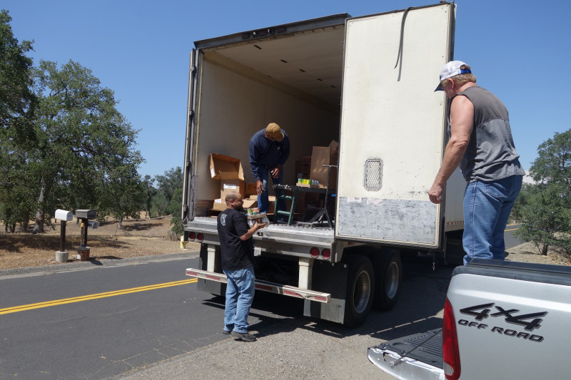 In one of the distributions tribal staff waits for Specialist ( Naz ) while specialist Ronald Buckman checks conveyor on one family's distribution. California Valley Miwok Tribe staff member Tiger Paulk waiting for Naz to bring good supplies