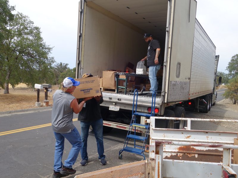 Already far along in transferring recipients tribal deliveries Specialist Ronald Buckman works with tribal staff as Specialist Naz waits with last of distribution. Tiger Paulk and Ronald Buckman carrying a heavy box of good supplies for the California Valley Miwok Tribe.