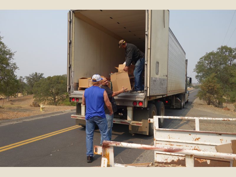 Working on the last distribution of the day will fill the need of a very large family that recently enrolled, as Specialist Naz laughs about how heavy the box is he is about to hand to tribal staff. California Valley Miwok Tribal staff unloading good supplies from truck.