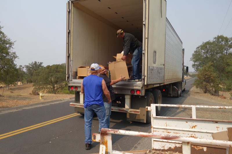 Working on the last distribution of the day will fill the need of a very large family that recently enrolled, as Specialist Naz laughs about how heavy the box is he is about to hand to tribal staff. California Valley Miwok Tribal staff unloading good supplies from truck.