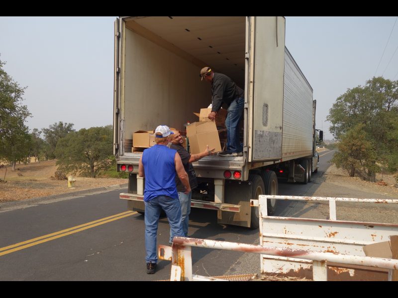 Working on the last distribution of the day will fill the need of a very large family that recently enrolled, as Specialist Naz laughs about how heavy the box is he is about to hand to tribal staff. California Valley Miwok Tribal staff unloading good supplies from truck.