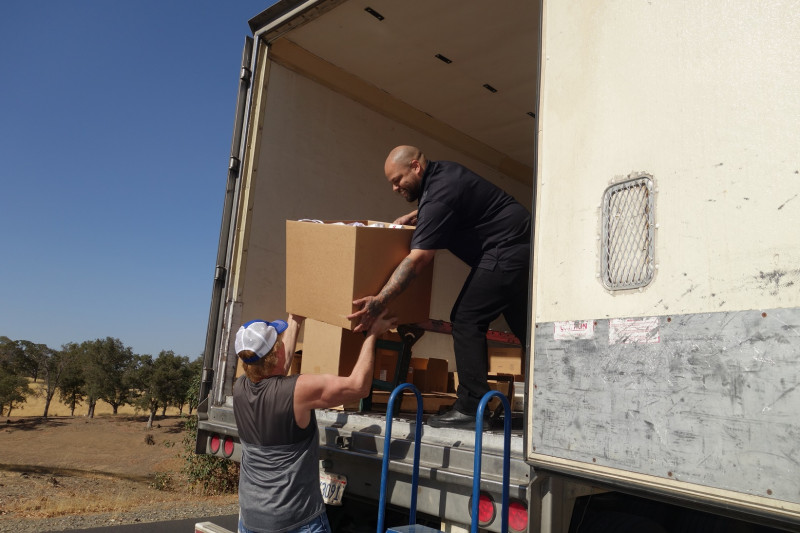 This box filled to the top was almost a complete distribution for one small family and specialist Naz and tribal staff took care when handling. California Valley Miwok Tribe's staff delivering good supplies for Californian Indian tribes.