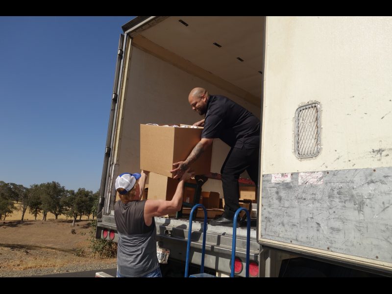 This box filled to the top was almost a complete distribution for one small family and specialist Naz and tribal staff took care when handling. California Valley Miwok Tribe's staff delivering good supplies for Californian Indian tribes.