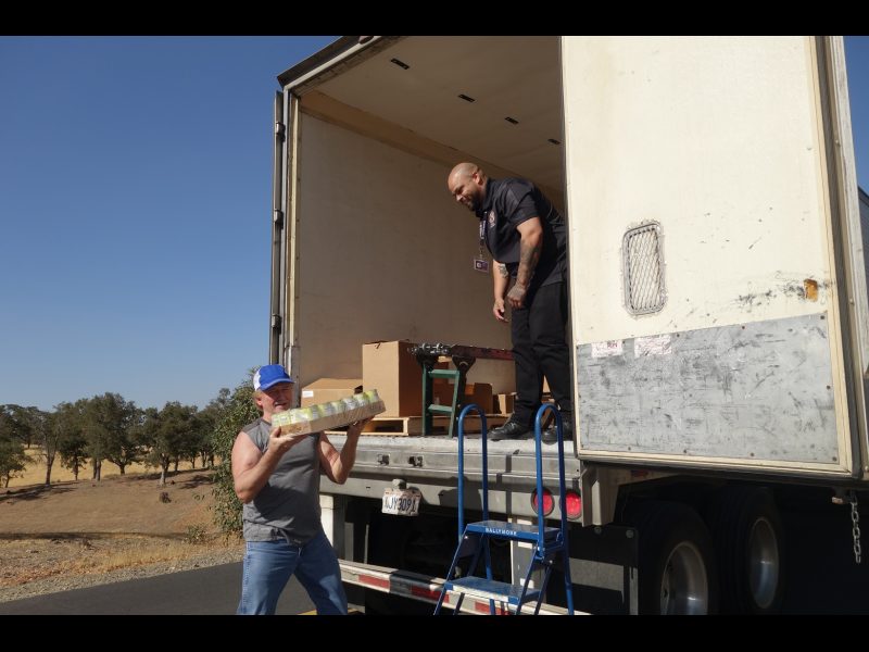 The last of the day's distributions that will be delivered personally by the tribe to those unable to attend in person. California Valley Miwok Tribe's staff unloading good supplies.