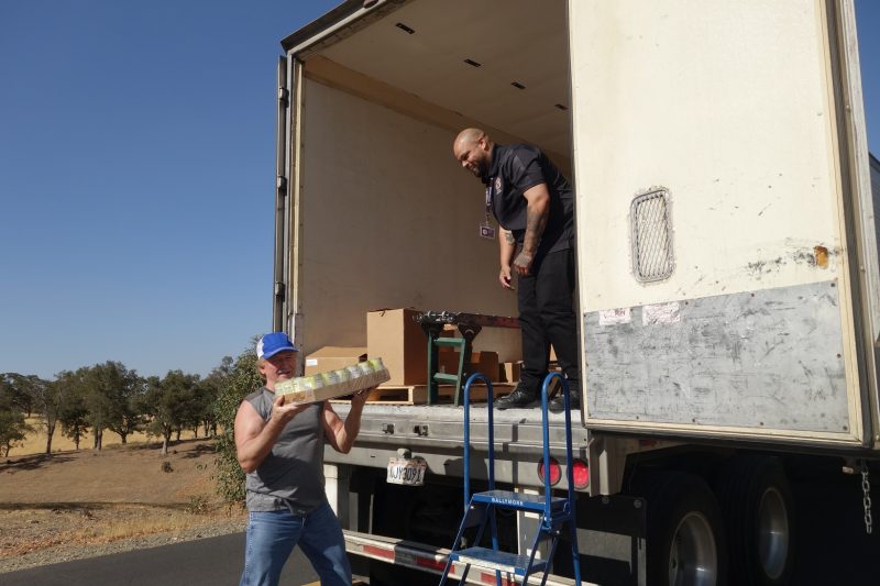 The last of the day's distributions that will be delivered personally by the tribe to those unable to attend in person. California Valley Miwok Tribe's staff unloading good supplies.