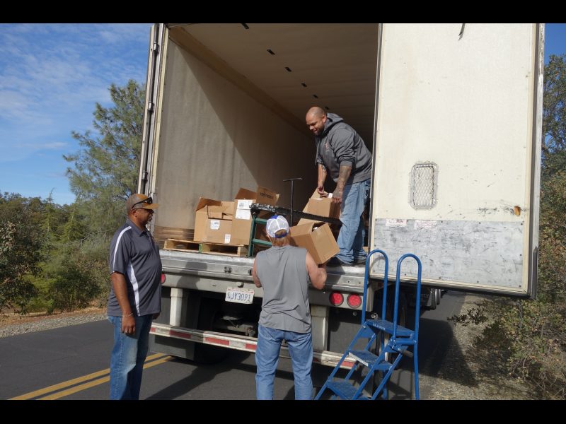 About to finish one distribution, Tule River Food Distribution Specialists
listen to an answer to a question asked about a current tribal issue. Tule River Food Distribution Specialists helping California Valley Miwok Tribal staff Tiger Paulk to unload good supplies.