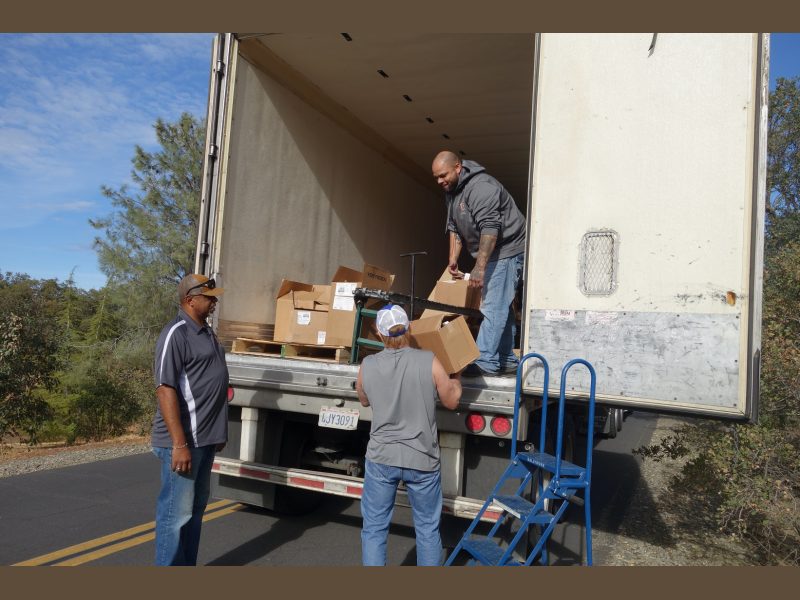 Tule River Food Distribution Specialists helping California Valley Miwok Tribal staff Tiger Paulk to unload good supplies.