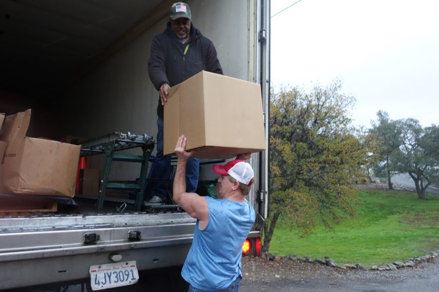 Specialist Ronald Buckman working with tribal staff unloading one of the larger boxes of the distribution. California Valley Miwok Tribe's staff unloading goods during a USDA Food Distribution.
