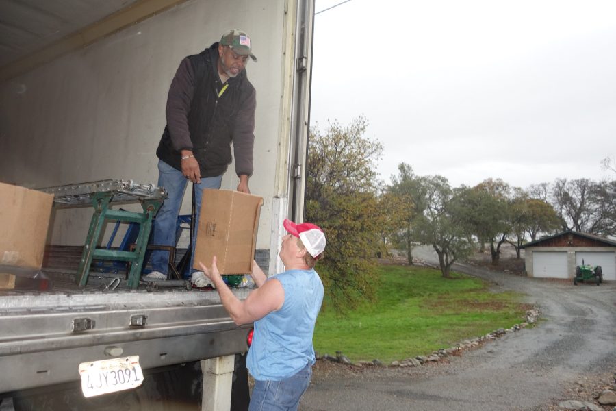 Last box of the day, did not photograph this month's trailer full of distributions due to having to keep trailer tarped due to the rain. California Valley Miwok Tribe's staff unloading goods during a USDA Food Distribution.
