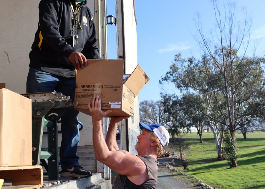 Although the box shown was originally egg mix it was full of canned fruits,
vegetables and meats. California Valley Miwok Tribe's staff unloading goods during a USDA Food Distribution.
