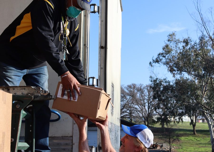 One of the last boxes of today's distributions, and although foggy in the distance was sunny and pleasant at the tribal offices. California Valley Miwok Tribe's staff unloading goods during a USDA Food Distribution.